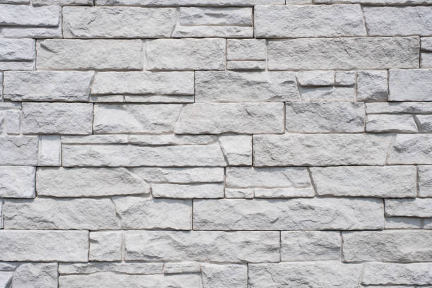 natursteinmauer hintergrund - granit stein textur gekachelt - cornerstone white stone textured stock-fotos und bilder