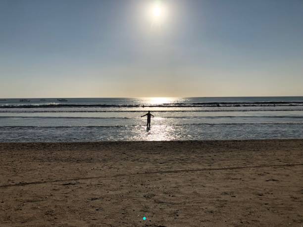 istock woman on a tropical beach in the sunset 1051447332