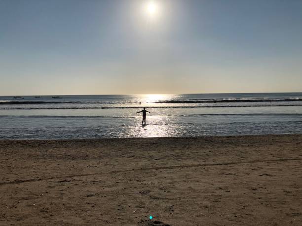 istock woman on a tropical beach in the sunset 1051447344