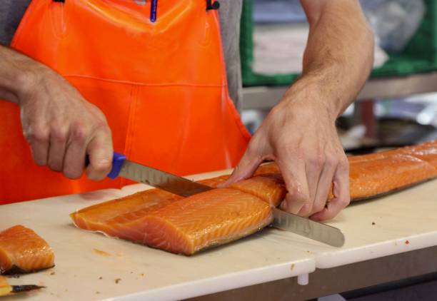 istock Cutting Fresh Salmon At Street Market 1051453012