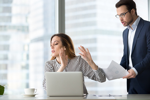 Bothered businesswoman rejecting accept document from colleague