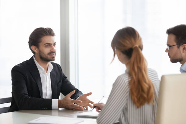 istock Confident male applicant talk at job interview 1051453420