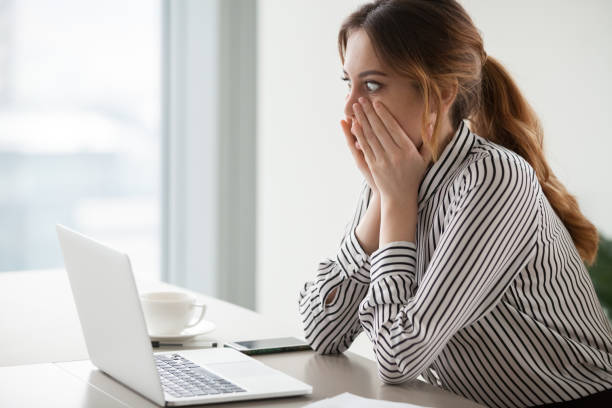 businesswoman rounding eyes shocked with company market crash - computer crime imagens e fotografias de stock