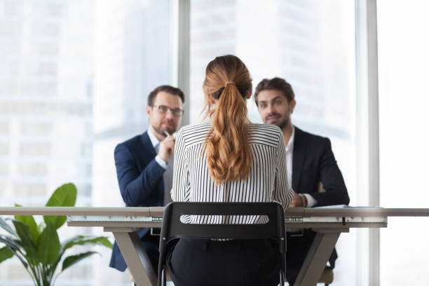 istock Female job candidate interview with doubting employers 1051453444
