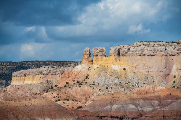 istock Colorful rock formations, cliffs, and mesa under a stormy sky at Ghost Ranch near Abiquiu, New Mexico 1051458730