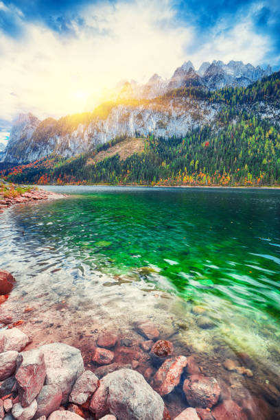 istock autumn scenery with Dachstein mountain summit reflecting in crystal clear Gosausee mountain lake in fall 1051460414
