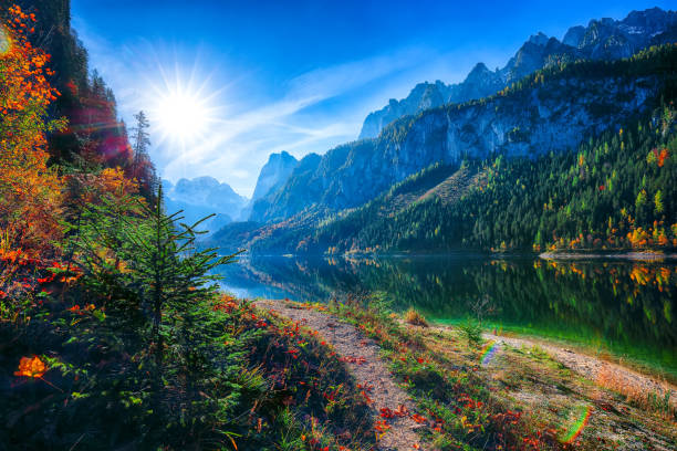 istock autumn scenery with Dachstein mountain summit reflecting in crystal clear Gosausee mountain lake in fall 1051462824