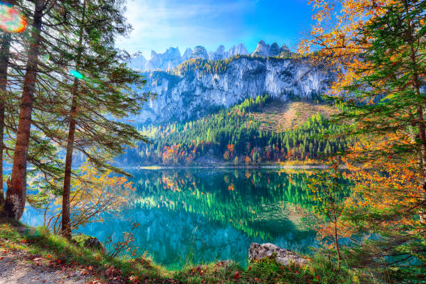 istock autumn scenery with Dachstein mountain summit reflecting in crystal clear Gosausee mountain lake in fal 1051463032