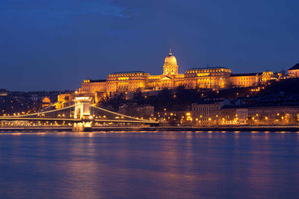 Royal Palace of Buda night view Budapest, Hungary - March 06, 2016: Illuminated Royal Palace across Danube river at night danube river stock pictures, royalty-free photos & images