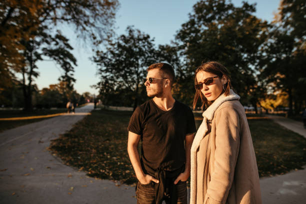 istock Young couple in park posing for photo 1051472422