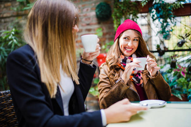 istock Two woman drinking coffee at cafe 1051472724