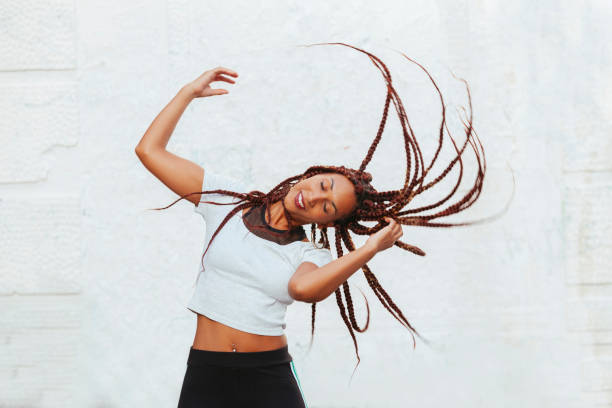 istock woman moving her long braids 1051478640