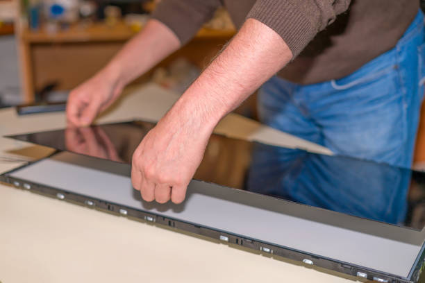 istock Replacing the screen in a LCD television, service center for repairing TVs, real work 1051478732