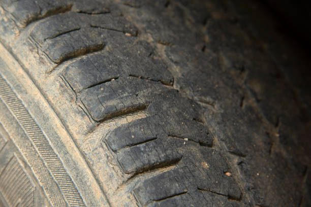 istock Damaged and worn black tire tread. 1051482162
