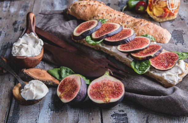 istock bruschetta with cream cheese figs and spinach leaves, on a wooden surface, rustic style 1051507538
