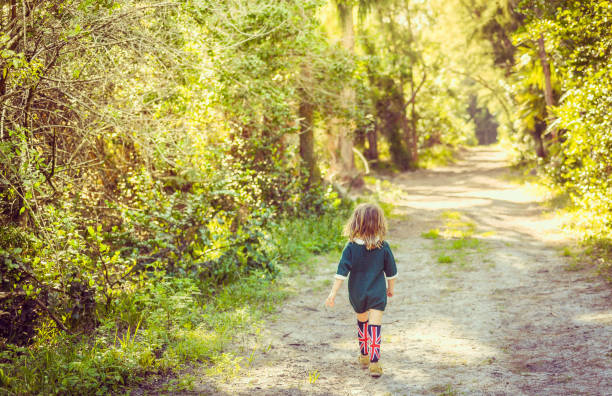 a mother with two children is walking along a forest path in the mountains. traveling and walking with kids. vacation in the winter.