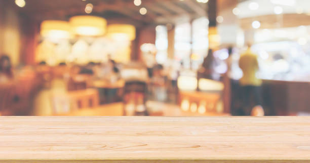 istock Restaurant interior with customer and wood table top over blur abstract background with bokeh light 1051513720