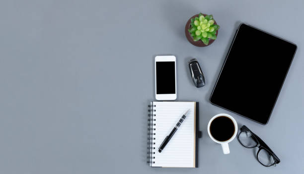 istock Flat lay view of gray desk with functional modern wireless technologies 1051516944