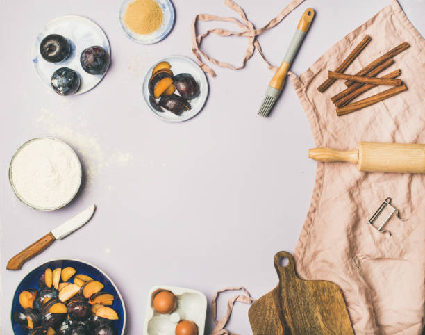 Baking ingredients and tools over pastel lilac background, copy space