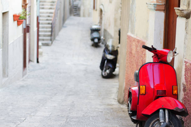 istock Sicily, Italy: Vintage Red Scooter on Cobbled Lane 1051526418