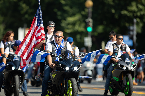 Washington, D.C., USA - September 29, 2018: The Fiesta DC Parade, Bikers from El Salvador carrying El Salvadoran Flags and the American Flag