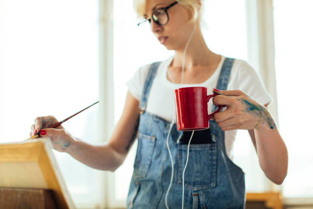 istock Girl painting on canvas 1051537482