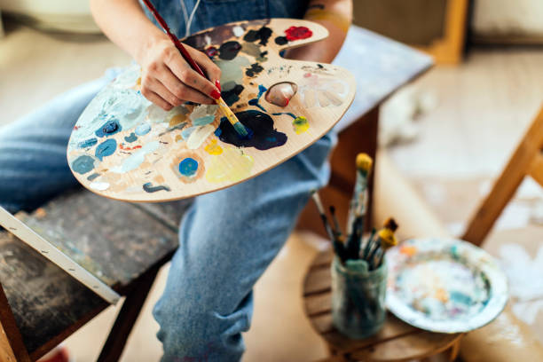 istock Mixing colors on a color palette 1051537508