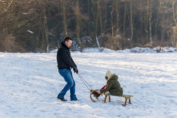 istock Father and daughter on a sled 1051537970
