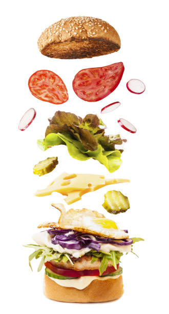 istock Big tasty burger with flying ingredients on white 1051541446