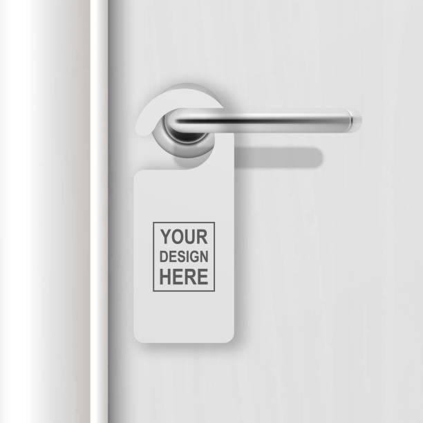 Vector realistic paper white blank door hanger on white realistic wooden door with metal silver handle background. Door hanger mockup. Design template for graphics. Full length door is in a clipping mask Vector realistic paper white blank door hanger on white realistic wooden door with metal silver handle background. Door hanger mockup. Design template for graphics. Full length door is in a clipping mask. door handle stock illustrations