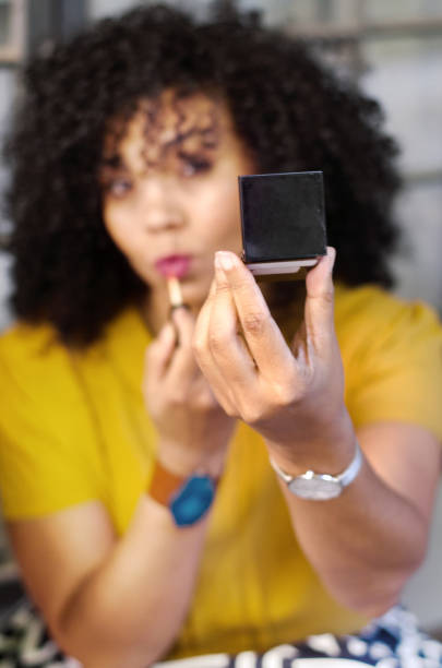 istock Beautiful mixed race woman checking her makeup 1051546090