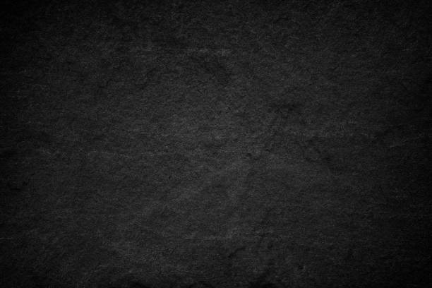 istock Dark grey black slate background or natural stone texture. 1051546634