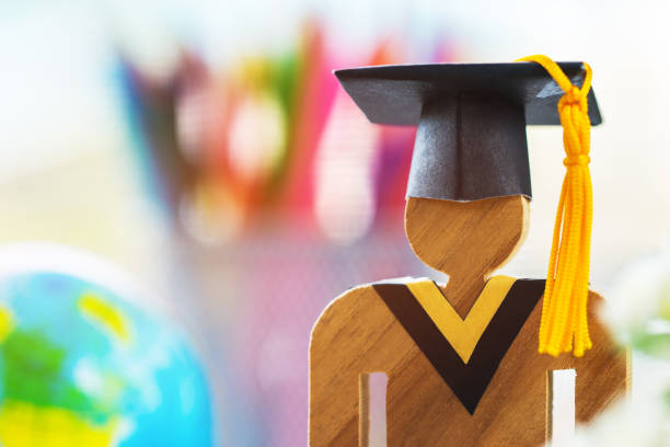 istock Education knowledge learning study abroad international Ideas. People Sign wood with Graduation celebrating cap on open textbook with model global map, alternative studying world wide 1051554988