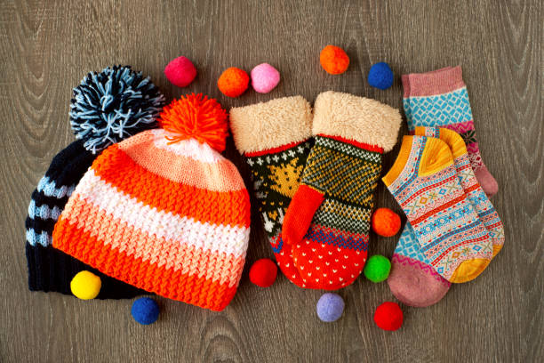 istock Caps, mittens and socks for cold seasons. 1051560792