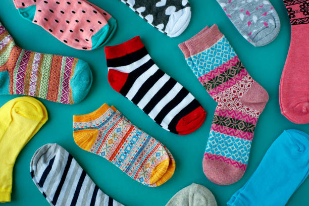 istock Many multicolored socks on a turquoise background. 1051560798