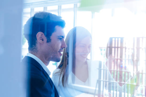 istock Three Business people is writing idea on to post it windows for team plan 1051560830