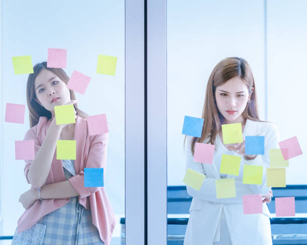 istock Business people is writing idea on to note paper for planning 1051560840