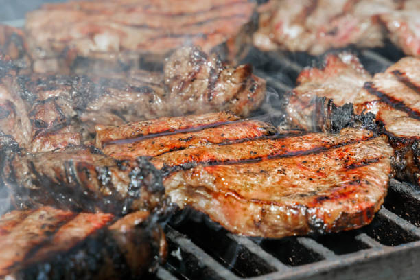 istock Meat steaks are cooked on a hot grill with smoke 1051569088