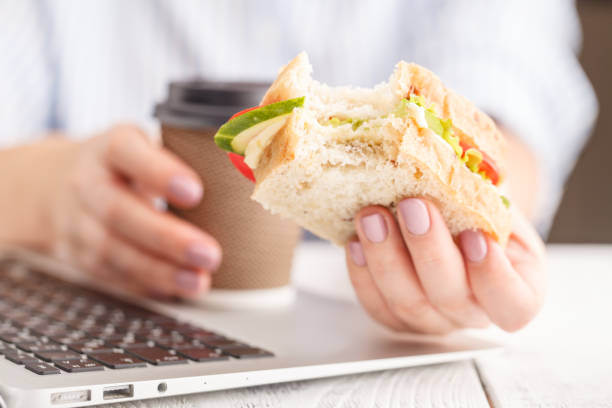 istock Bitten cheese and lettuce sandwich in hand, whole sandwich 1051577516
