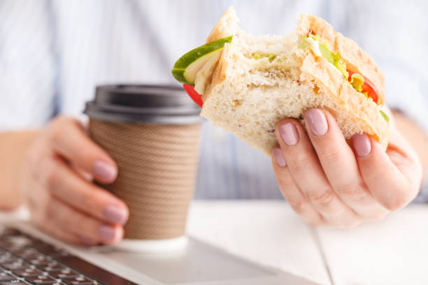 istock Woman working and eating at office desk 1051577582