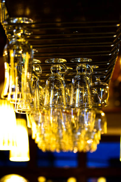 istock Glasses on a bar hanging upside down. The bar counter in the cafe 1051584676