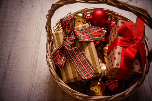 istock present boxes in basket in vintage style. Copy space. crafted box with a gift. Vintage gift box on old wooden background. gift parcel box with ribbon bow. 1051588014