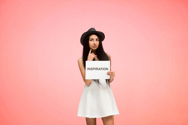 istock Beautiful female on pink background is feeling inspired 1051591504