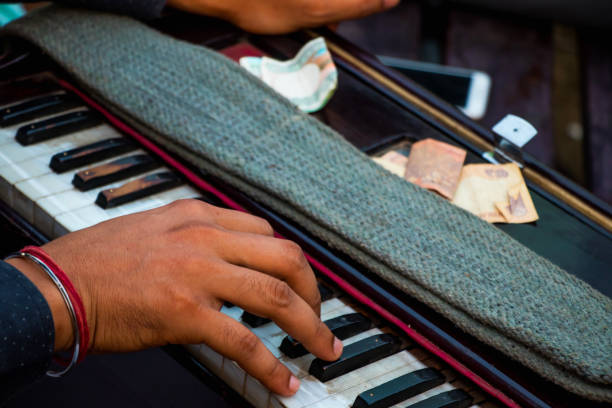 istock Image of a human hand playing on Harmonium in public place 1051593938