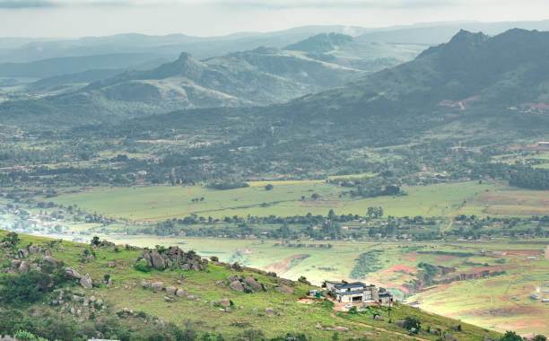 Ezulwini valley in Swaziland Eswantini with beautiful mountains, trees and rocks in scenic green valley between Mbabane and Manzini cities. Traditional huts houses of Swaziland