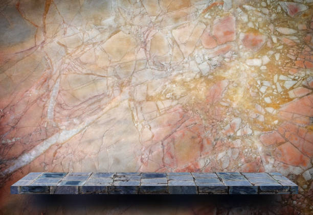 istock Blank stone gray display shelf on grunge marbel wall 1051599484