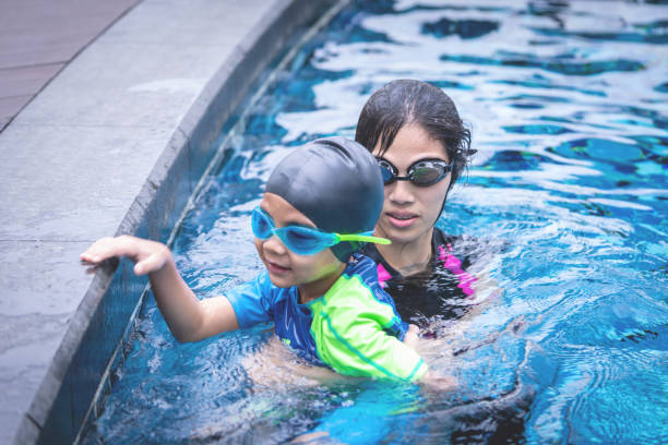 istock Mother is teaching her son to swim 1051599540