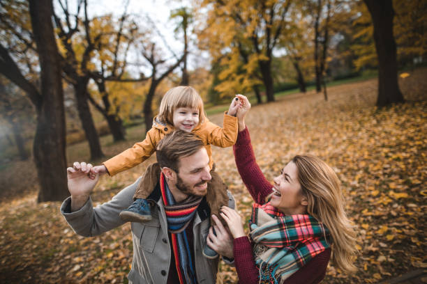istock Happy parents having fun with their small son in autumn day. 1051605512