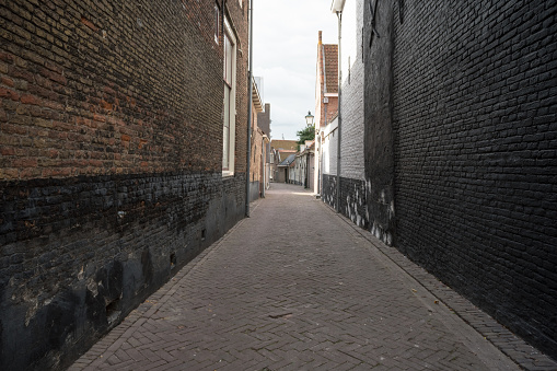 an narrow alley in the city on a bright day