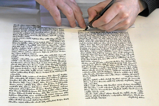 Sofer writing a sefer Torah in Hebrew. In the Torah's 613 commandments, the second to last is that every Jew should write a Sefer Torah in their lifetime.